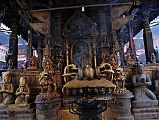 
Kathmandu Patan Golden Temple - The Entrance Door To The Swayambhu Chaitya Is Guarded By Two Snow Lions And Has A Vajra And Many Statues Including The King And Queen
